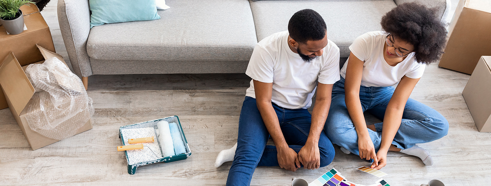 Couple Sitting On Floor Looking at Paint Swatches